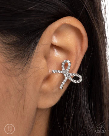 Convincing Charm - White Rhinestone Silver Bow Ear Cuff Earrings - Paparazzi